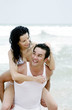 Man carrying his girlfriend on his back