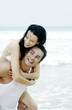 Man carrying his girlfriend on his back
