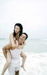 Man carrying his girlfriend on his back