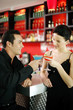 Couple holding drinks while hanging out in a bar