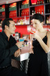 Couple holding drinks while hanging out in a bar