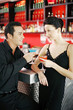 Couple holding drinks while hanging out in a bar