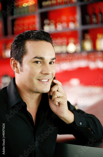 Photo: Man smiling while talking on the mobile phone Man smiling while talking on the mobile phone
