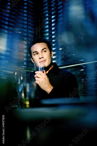 Photo: Man enjoying a glass of alcoholic beverage in the restaurant Man enjoying a glass of alcoholic beverage in the restaurant