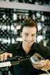 Photo: Man pouring a bottle of wine into a wine glass Man pouring a bottle of wine into a wine glass
