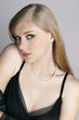 Young woman in black evening dress and pearl necklace