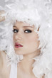 Young woman with white feathers posing for the camera