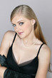 Young woman in black evening dress and pearl necklace