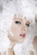 Young woman with white feathers posing for the camera