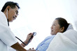 Doctor examining patient in a ward