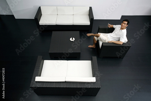 Photo: Guy resting in a spacious living room Guy resting in a spacious living room