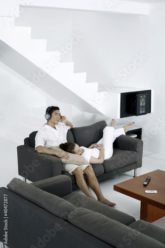 Photo: Couple resting in living room Couple resting in living room