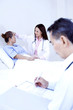 Doctor examining patient in a ward