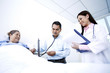 Doctor examining patient in a ward