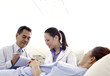 Doctors checking on patient