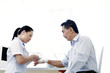 Nurse bandaging a patient's hand