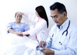 Doctor examining patient in a ward