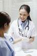 Female doctor cleaning her patient's arm before an injection