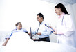 Doctor examining patient in a ward