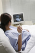 Photo: Pregnant woman lying on the bed smoking Pregnant woman lying on the bed smoking