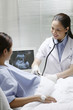 Photo: Female doctor checking on a pregnant woman Female doctor checking on a pregnant woman