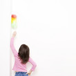 Girl dusting the wall with a feather duster