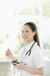 Photo: Female doctor holding palmtop Female doctor holding palmtop