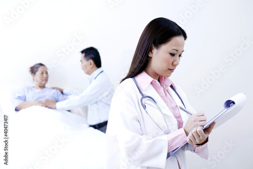 Photo: Doctor examining patient in a ward Doctor examining patient in a ward