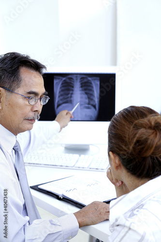 Photo: Doctor consulting patient Doctor consulting patient