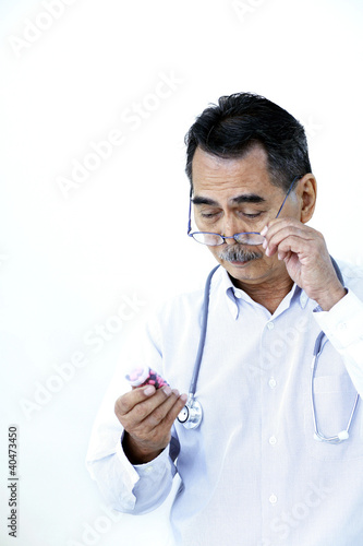Photo: Doctor examining medicine Doctor examining medicine