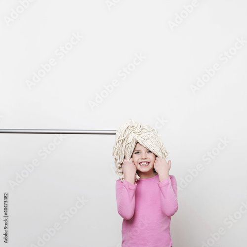 Photo: A girl (5-7) with a mop on her head A girl (5-7) with a mop on her head