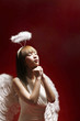 Young woman in angel costume making a wish