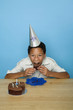 Boy with party hat eating cake