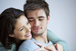 Woman hugging her boyfriend from behind