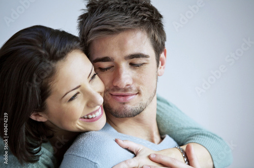 Photo: Woman hugging her boyfriend from behind Woman hugging her boyfriend from behind