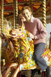 A senior couple having fun on a carousel
