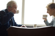 A couple drinking coffee, face to face in a cafe