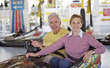 A mature couple posing for a picture in a bumper car