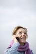 A woman smiling and talking on the mobile 