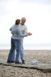 A mature couple dancing on a platform at the beach