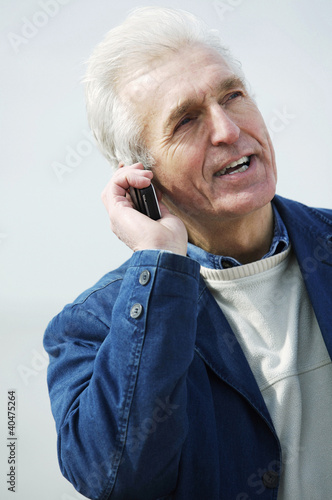 Photo: A man talking on the phone A man talking on the phone