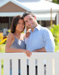 Couple standing in front of new home