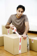 Man sealing up boxes