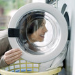 Woman loading clothes into the washing machine