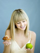Foto: Woman with a cupcake and green apple Woman with a cupcake and green apple