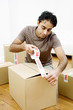 Man sealing up boxes