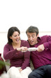 A couple grabbing a gift excitedly