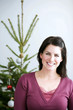 Woman standing in front of a Christmas tree