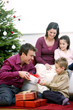 Family gathering around the Christmas tree