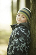 Boy leaning on a tree